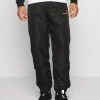 Sergio Tacchini CARSON PANTS - Tracksuit Bottoms - Black/harvest Gold -Sergio Tacchini Sales 2e07f9052d08411b98a2f3fb04cd2f31
